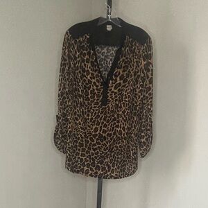 Animal print blouse. Cute button details. Black accent panels.